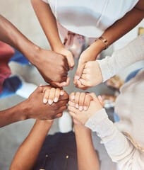 people standing in a circle holding hands