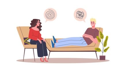 Woman therapist seated and talking to a man client sitting on her couch