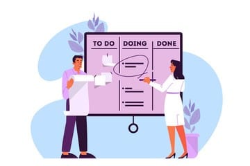 man and woman staning in front of a chart with three columns, to do, doing and done